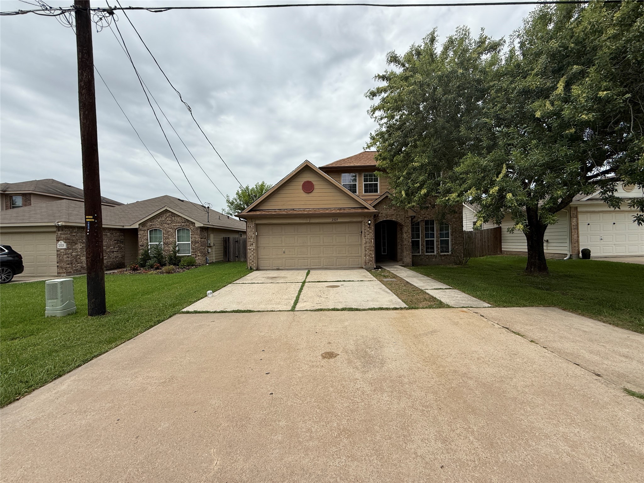 a view of a white house with a big yard and large trees