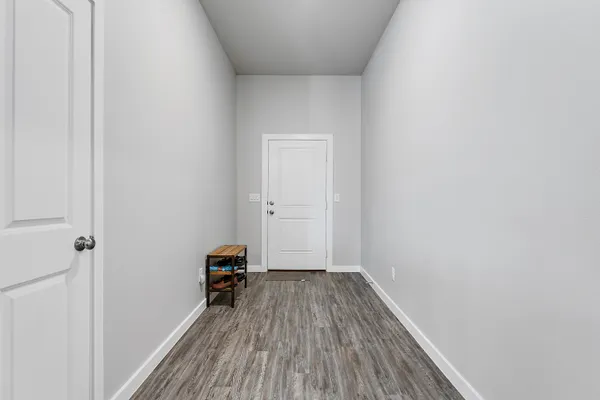 a view of a room with wooden floor and a window