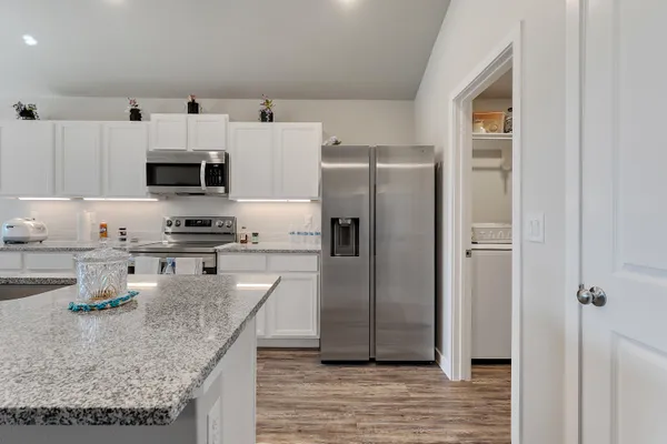 a kitchen with refrigerator and stove