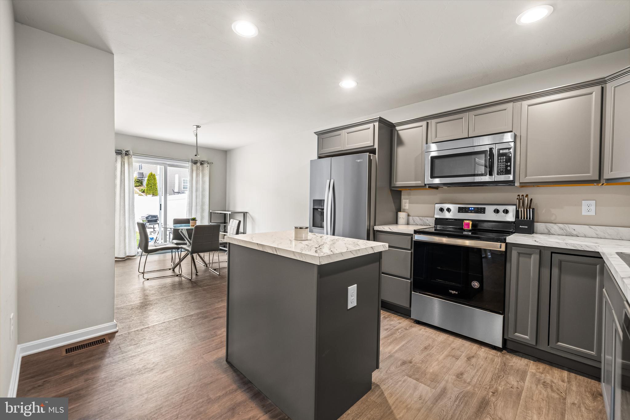 177 Skyview Circle Hanover, PA 17331 - Photo 6 of 18 a kitchen with granite countertop a stove top oven and cabinets