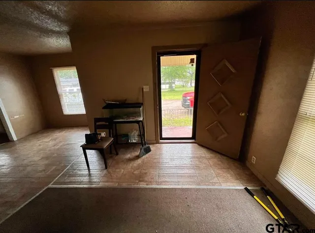 a living room with furniture rug and a window
