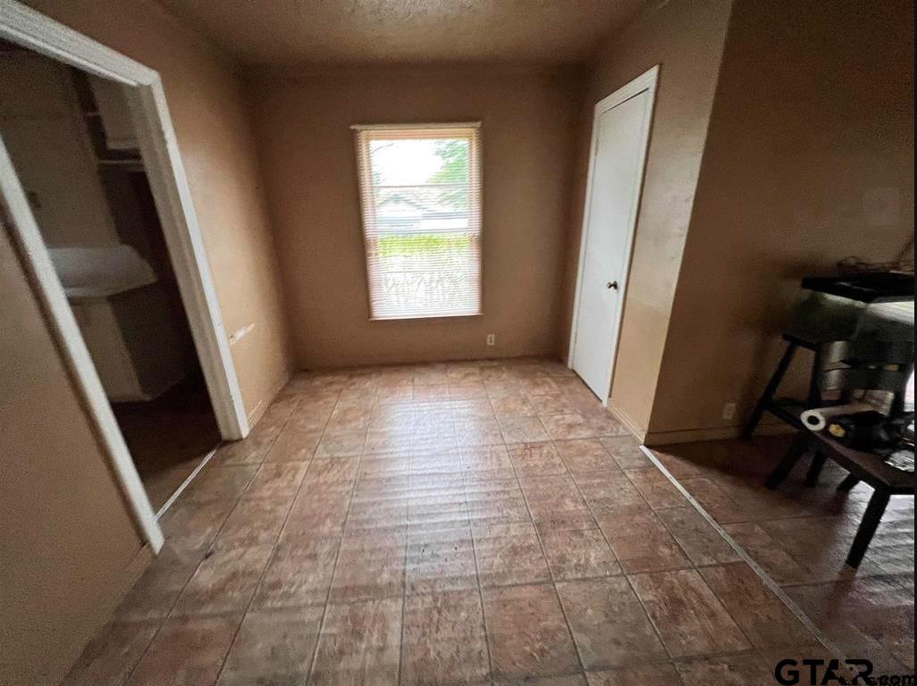 242 East Main Street Van, TX 75790 - Photo 9 of 20 a view of an empty room with stairs and a window