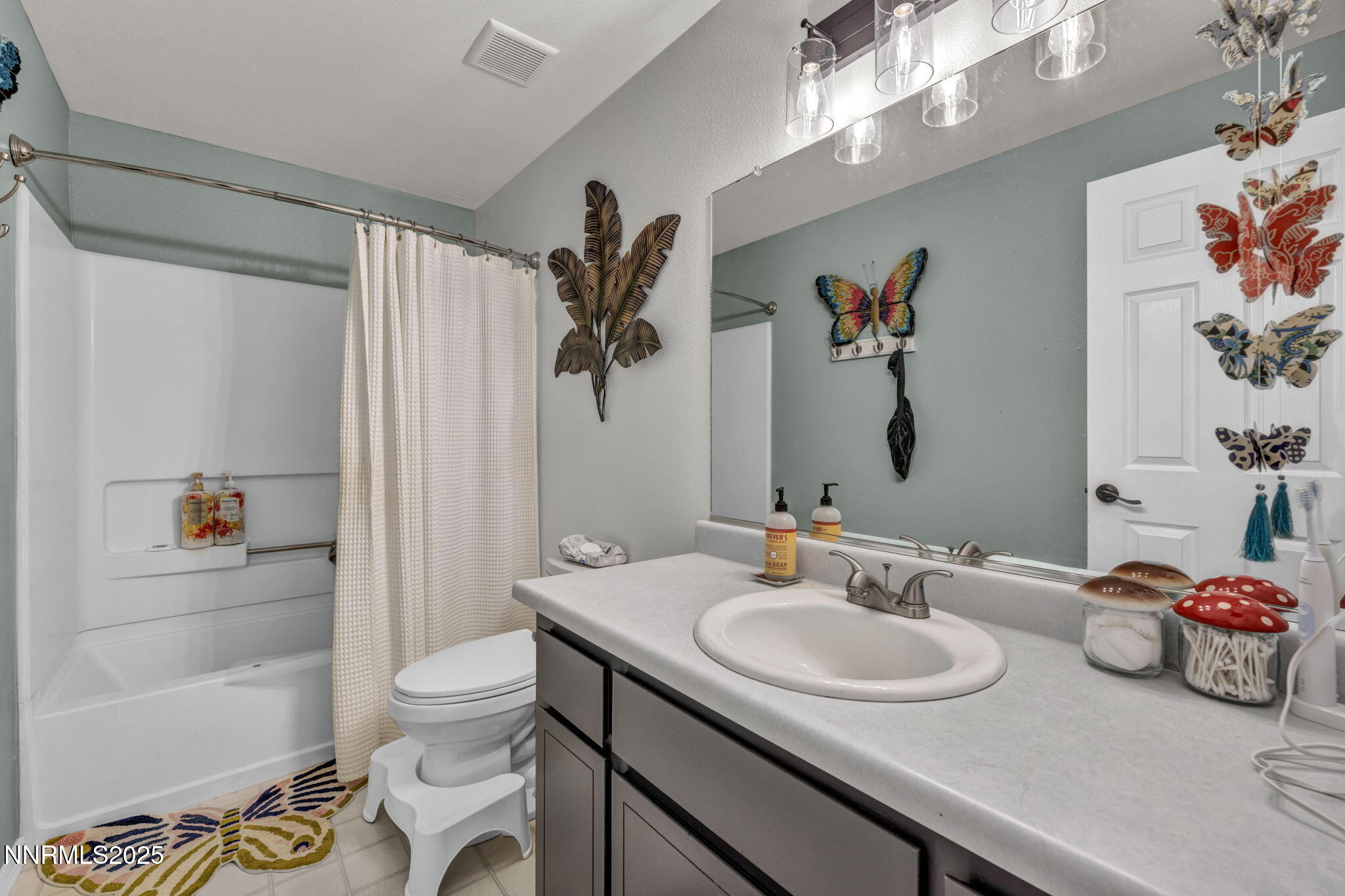 216 Gordon Lane Dayton, NV 89403 - Photo 12 of 16 a bathroom with a granite countertop sink a toilet and a shower curtain