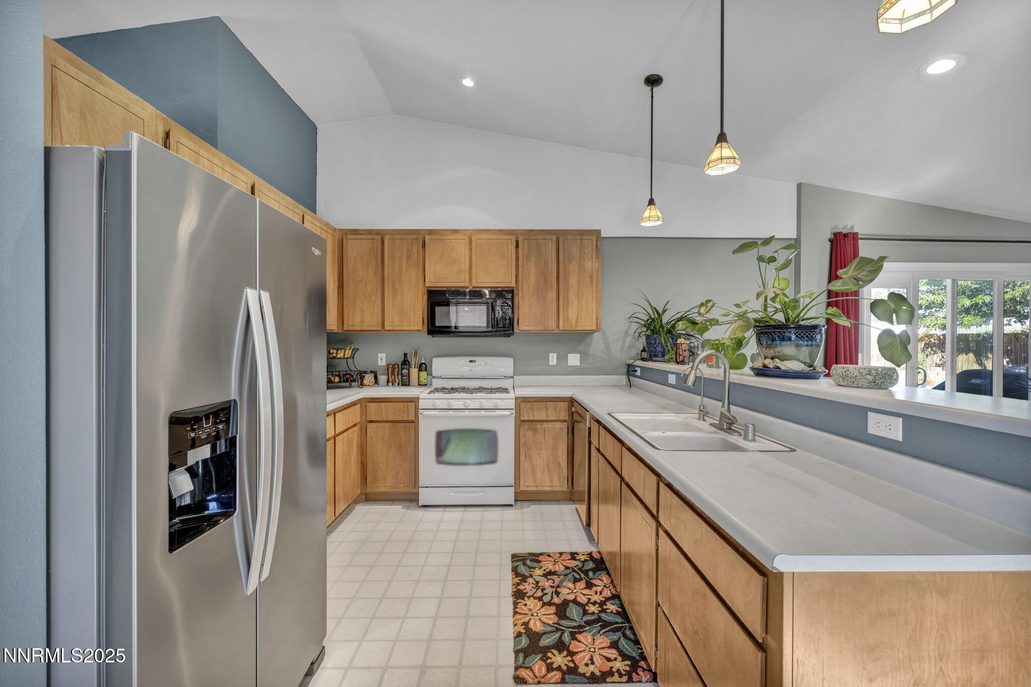 216 Gordon Lane Dayton, NV 89403 - Photo 4 of 16 a kitchen with stainless steel appliances granite countertop a refrigerator a sink dishwasher a oven with white cabinets and wooden floor