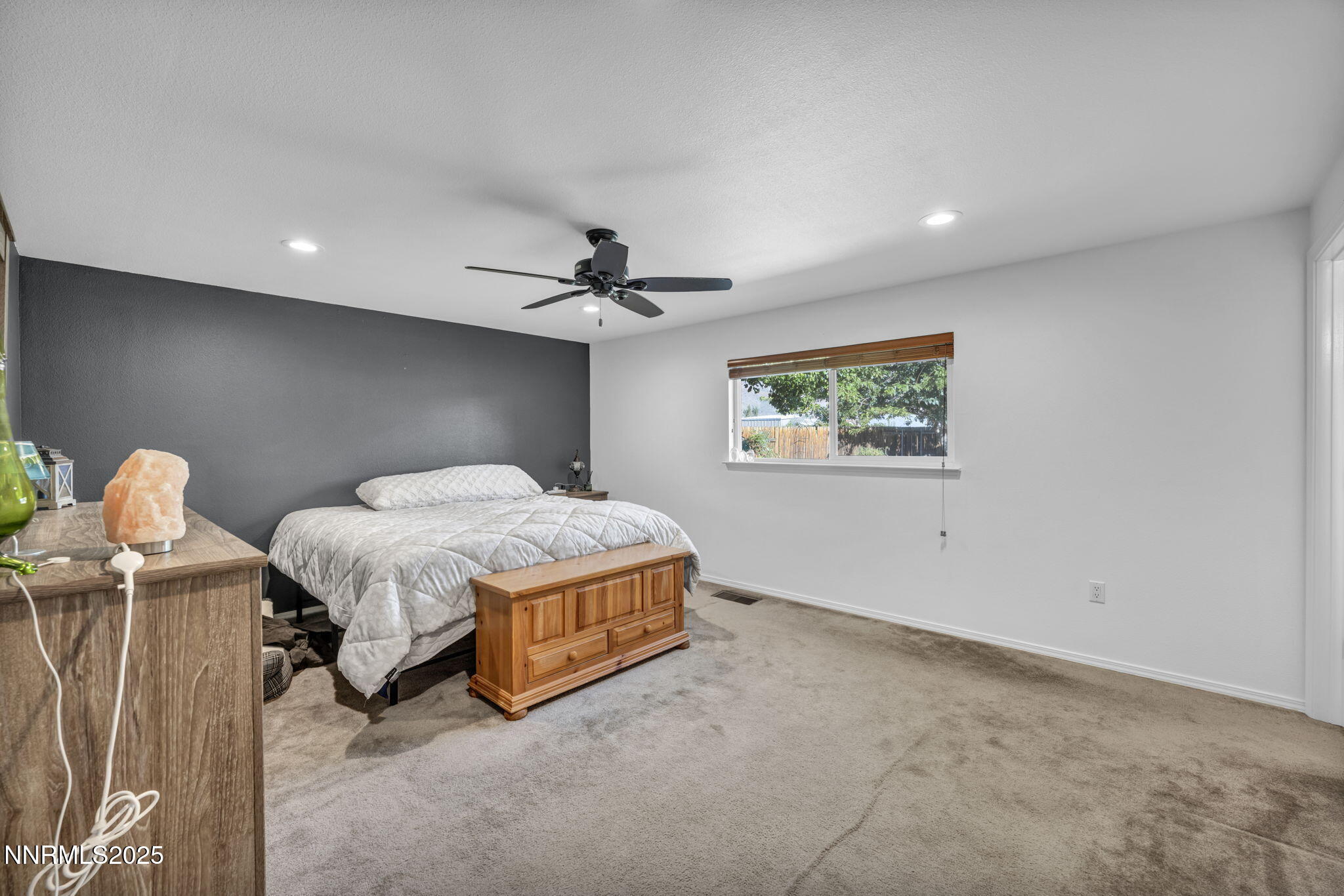 216 Gordon Lane Dayton, NV 89403 - Photo 9 of 16 a spacious bedroom with a bed and a chandelier