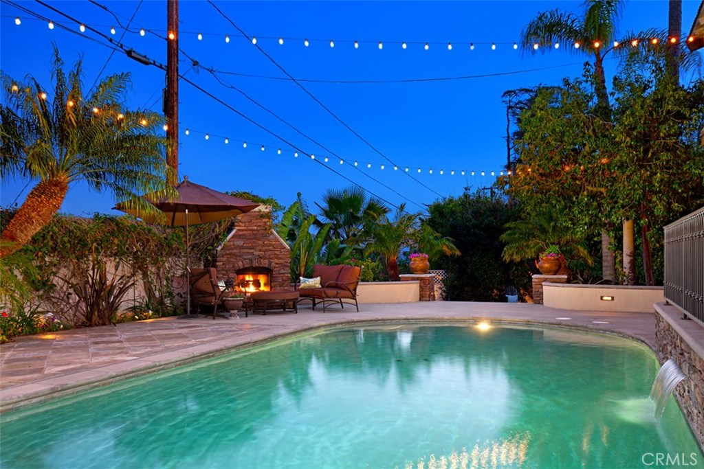 a swimming pool view with a sitting space