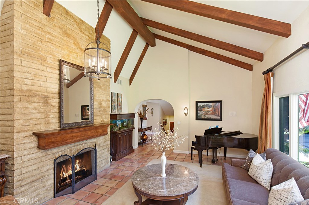 13032 St Thomas Drive North Tustin, CA 92705 - Photo 12 of 32 a living room with furniture a fireplace and a table