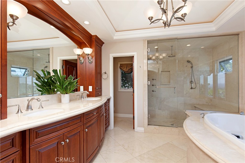 13032 St Thomas Drive North Tustin, CA 92705 - Photo 16 of 32 a bathroom with a double vanity sink mirror and shower