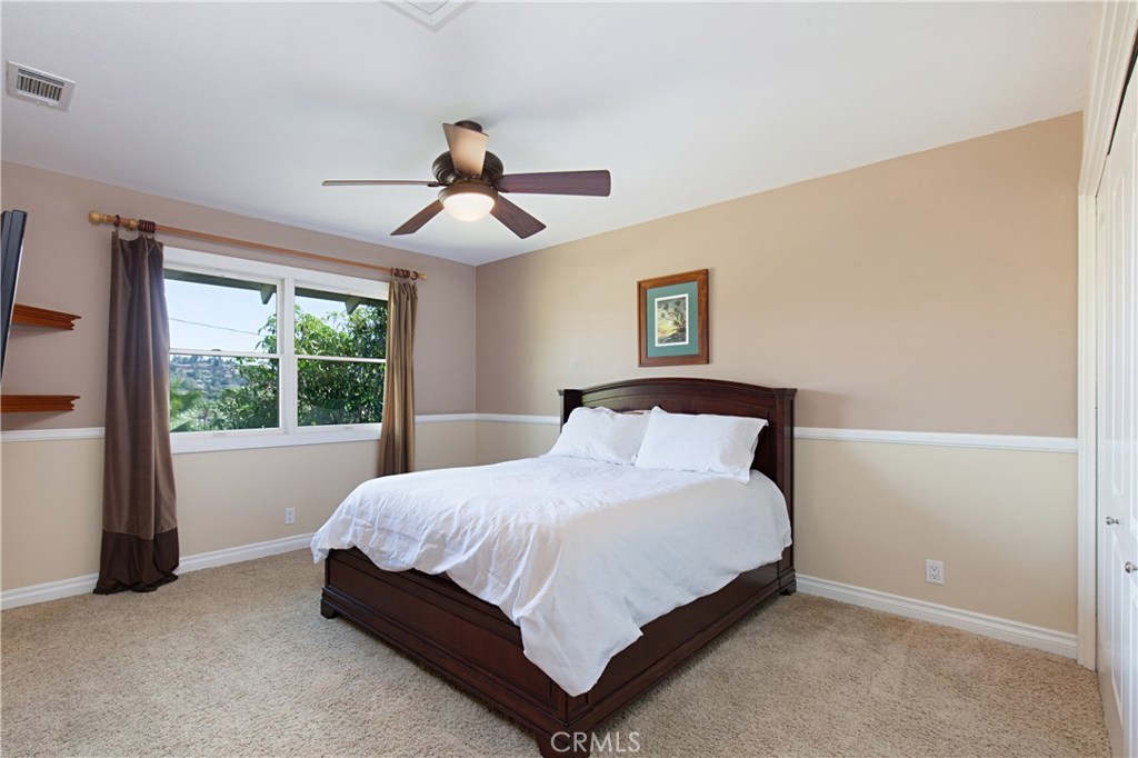 13032 St Thomas Drive North Tustin, CA 92705 - Photo 20 of 32 a large bed sitting in a bedroom next to a window