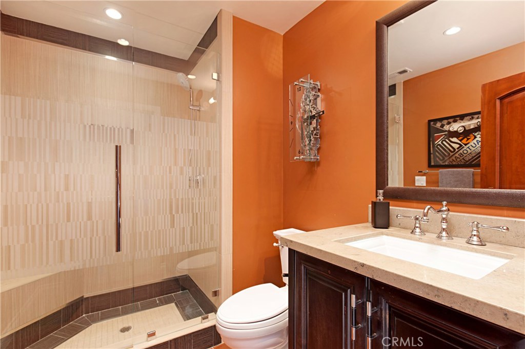 13032 St Thomas Drive North Tustin, CA 92705 - Photo 21 of 32 a bathroom with a sink a toilet and shower