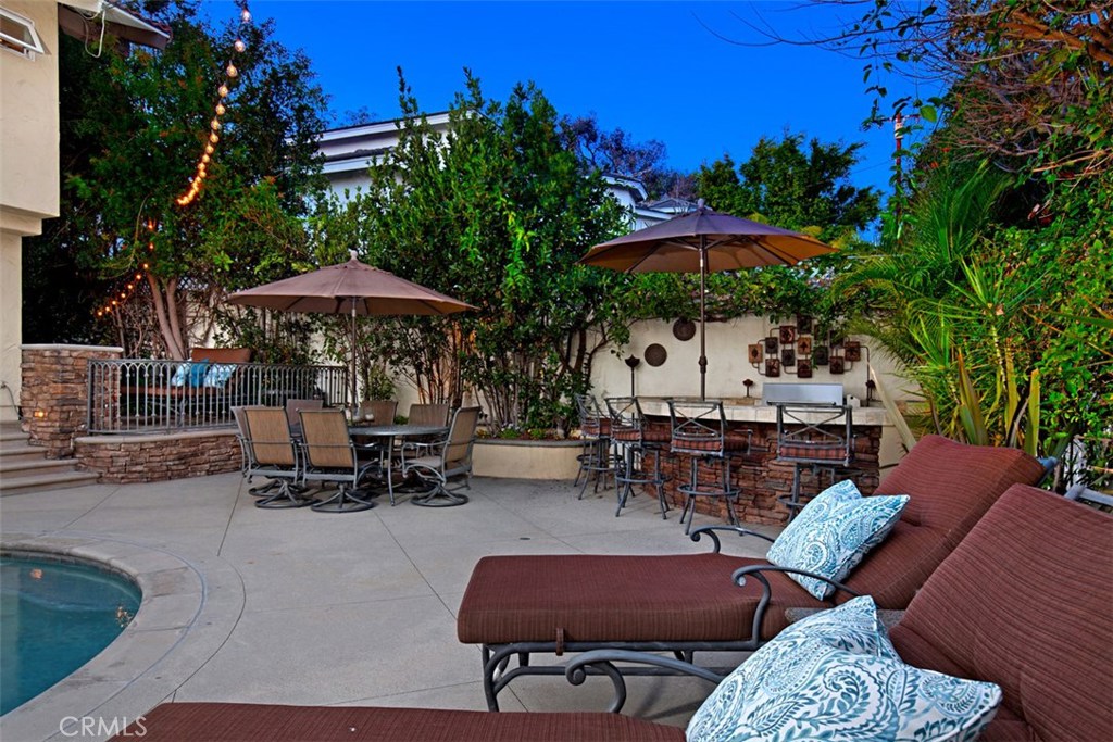 13032 St Thomas Drive North Tustin, CA 92705 - Photo 3 of 32 a view of a chairs and tables in the back yard of the house