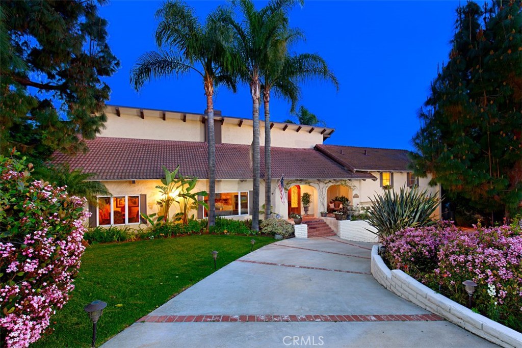 13032 St Thomas Drive North Tustin, CA 92705 - Photo 4 of 32 a view of a house with a yard and potted plants