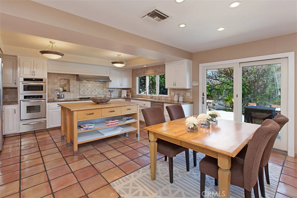 13032 St Thomas Drive North Tustin, CA 92705 - Photo 8 of 32 a dining room with a table and chairs