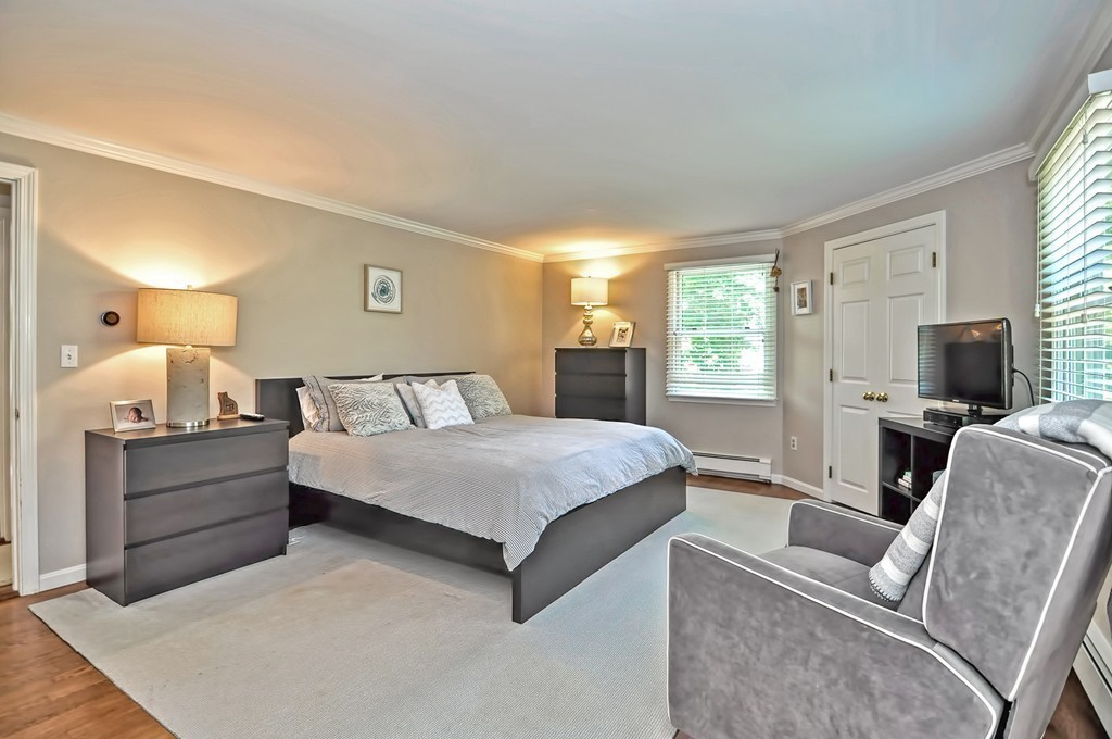 10 Pilgrim Road Wellesley, MA 02481 - Photo 11 of 25 a spacious bedroom with a large bed and a flat screen tv