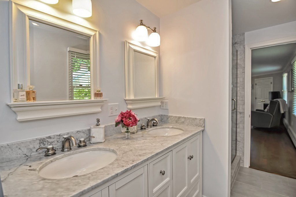 10 Pilgrim Road Wellesley, MA 02481 - Photo 12 of 25 a bathroom with a granite countertop sink a large mirror and a window