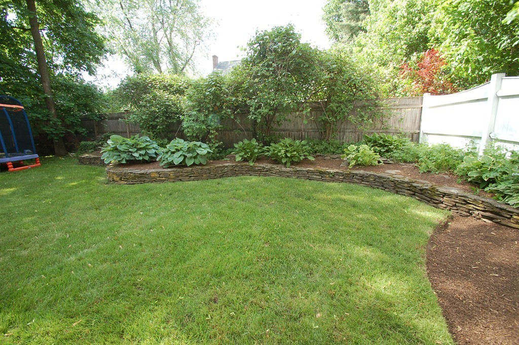 10 Pilgrim Road Wellesley, MA 02481 - Photo 23 of 25 a view of a garden with plants and large trees
