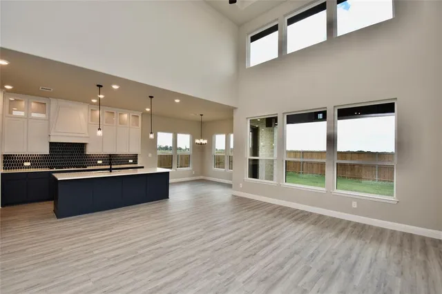 a view of kitchen with granite countertop cabinets and wooden floor
