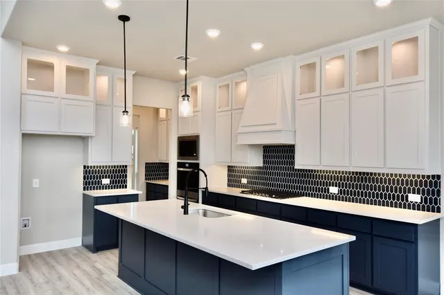 a kitchen with kitchen island a sink stainless steel appliances and cabinets
