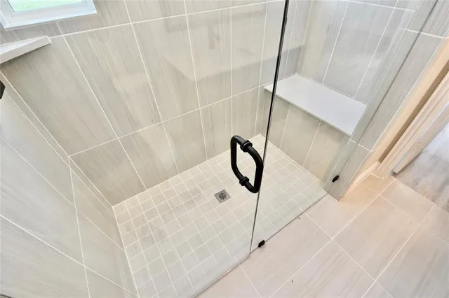 a kitchen with stainless steel appliances kitchen island granite countertop a refrigerator and a sink