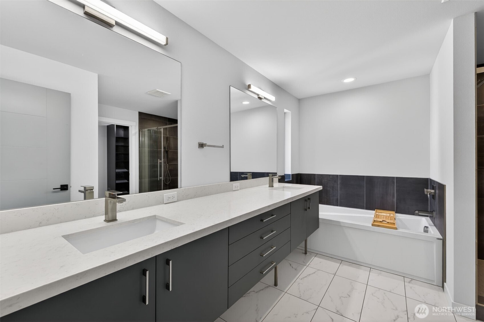 629 Bing Road, Unit B Lynnwood, WA 98036 - Photo 11 of 27 a bathroom with a sink a mirror and a bathtub