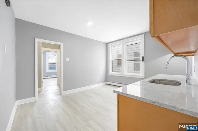 a kitchen with granite countertop wooden floors and sink