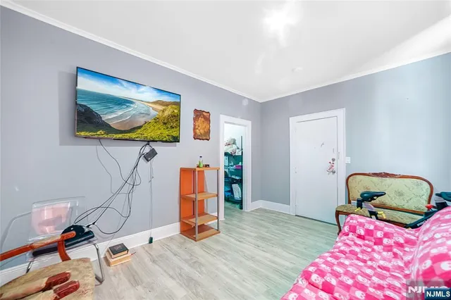 a bedroom with furniture and a flat screen tv