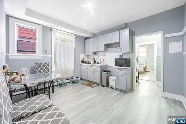 a living room with furniture a dining table and kitchen view