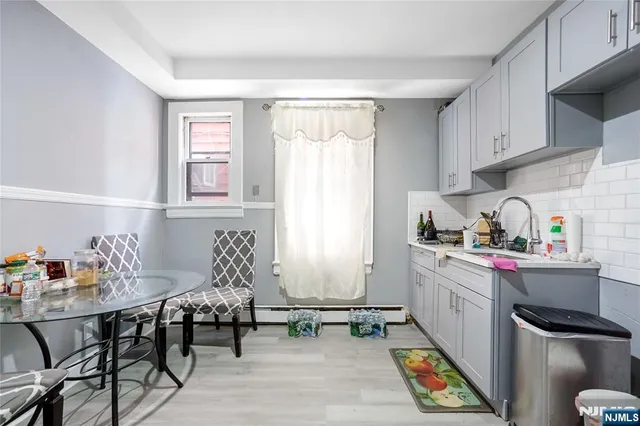 a kitchen with stainless steel appliances granite countertop a stove a sink dishwasher and cabinets with wooden floor