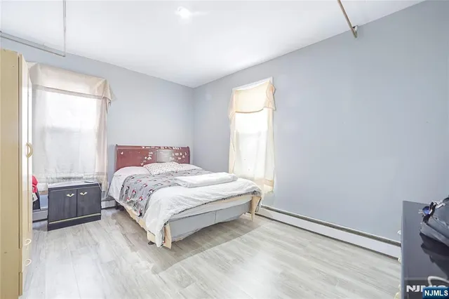 a spacious bedroom with a bed and a window