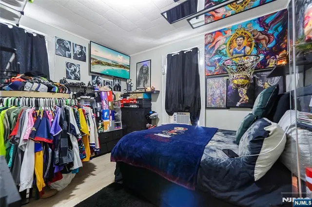 a view of walk in closet with clothes