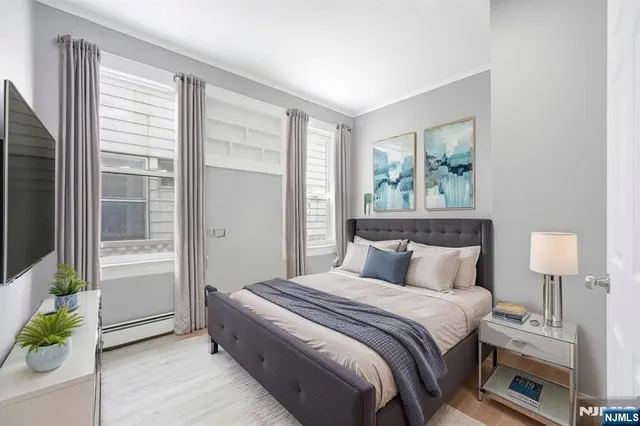 a bedroom with a bed and a lamp on table