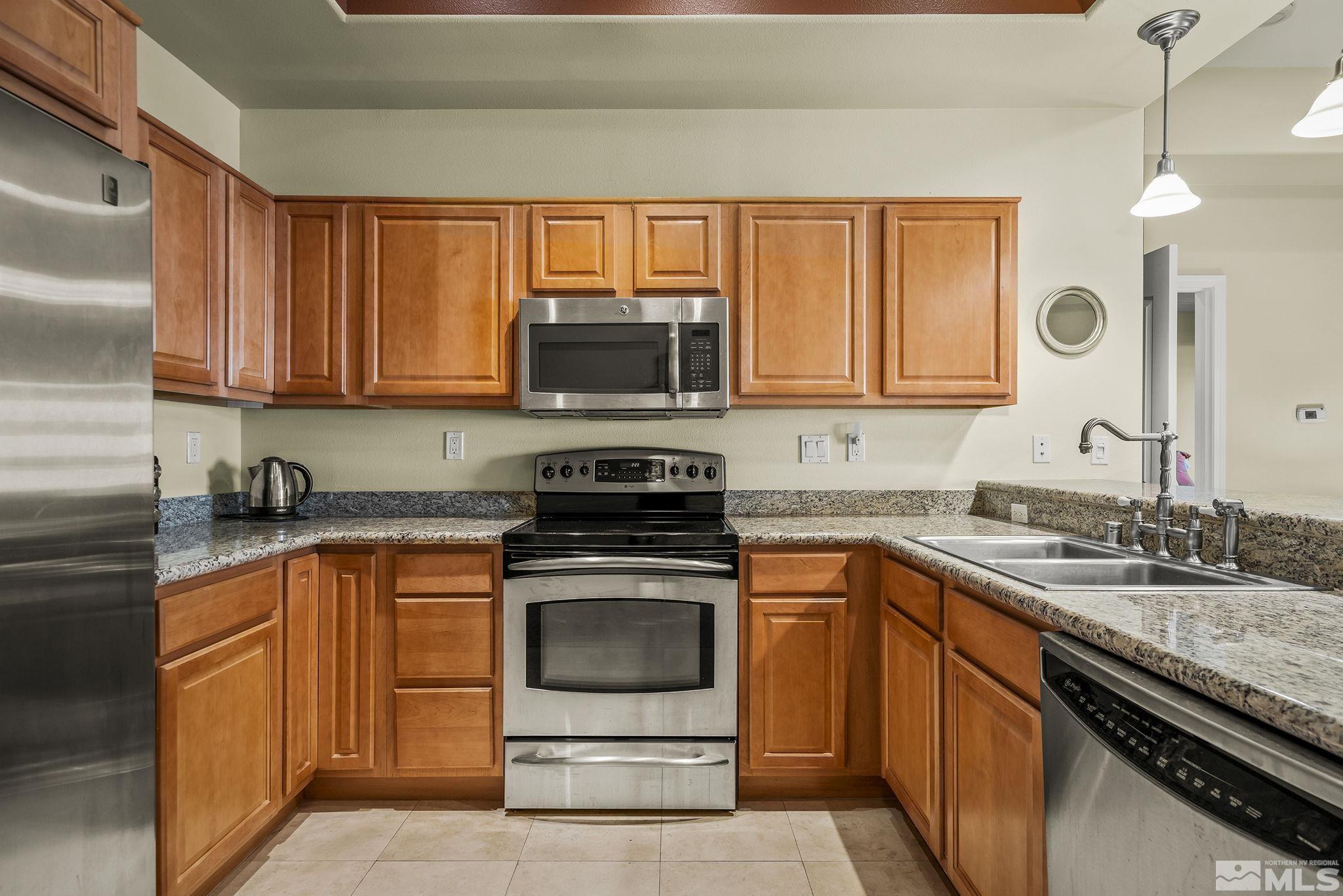 200 West 2nd Street, Unit 202 Reno, NV 89501 - Photo 3 of 18 a kitchen with a sink stove top oven and microwave