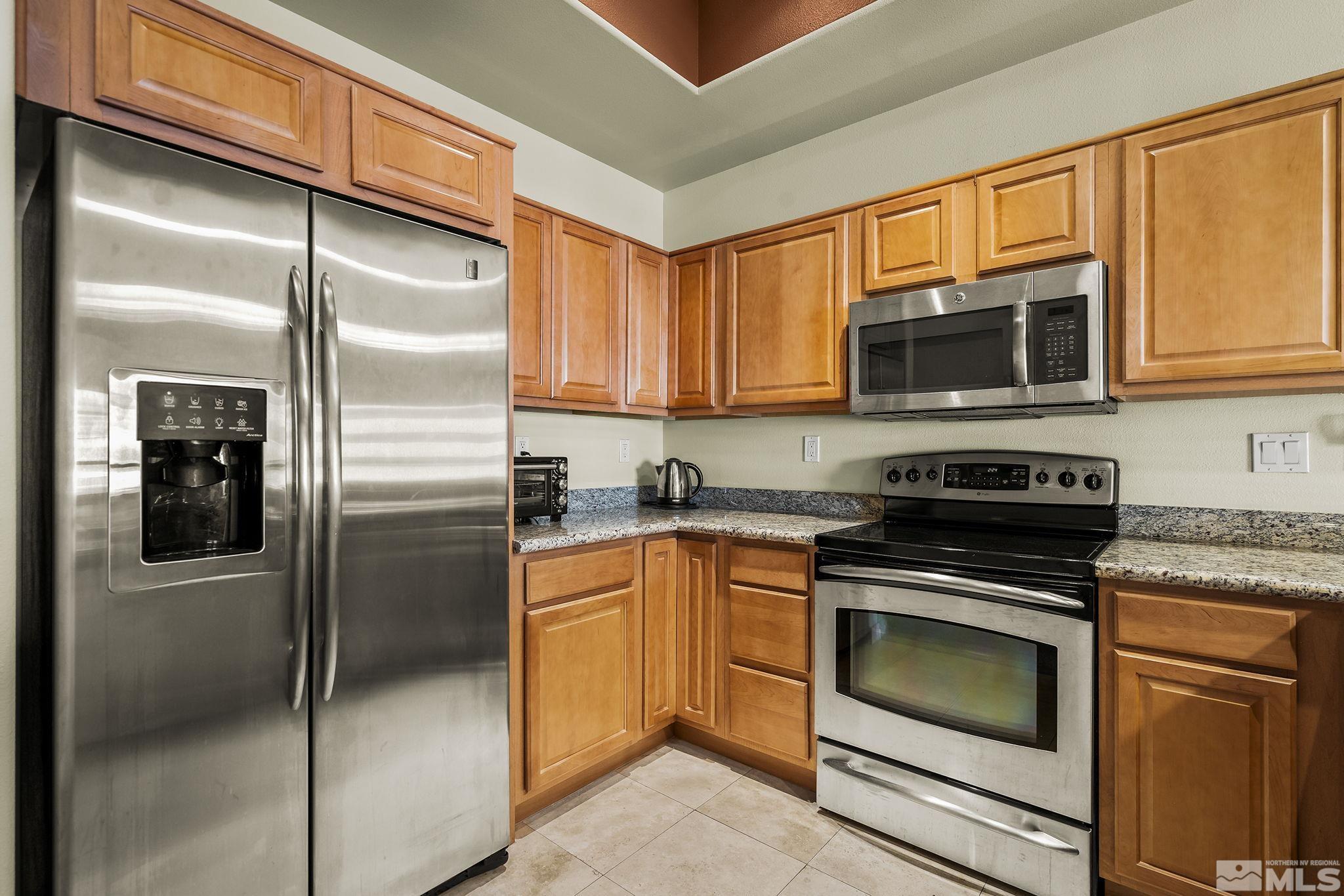 200 West 2nd Street, Unit 202 Reno, NV 89501 - Photo 4 of 18 a kitchen with stainless steel appliances granite countertop a refrigerator stove and microwave