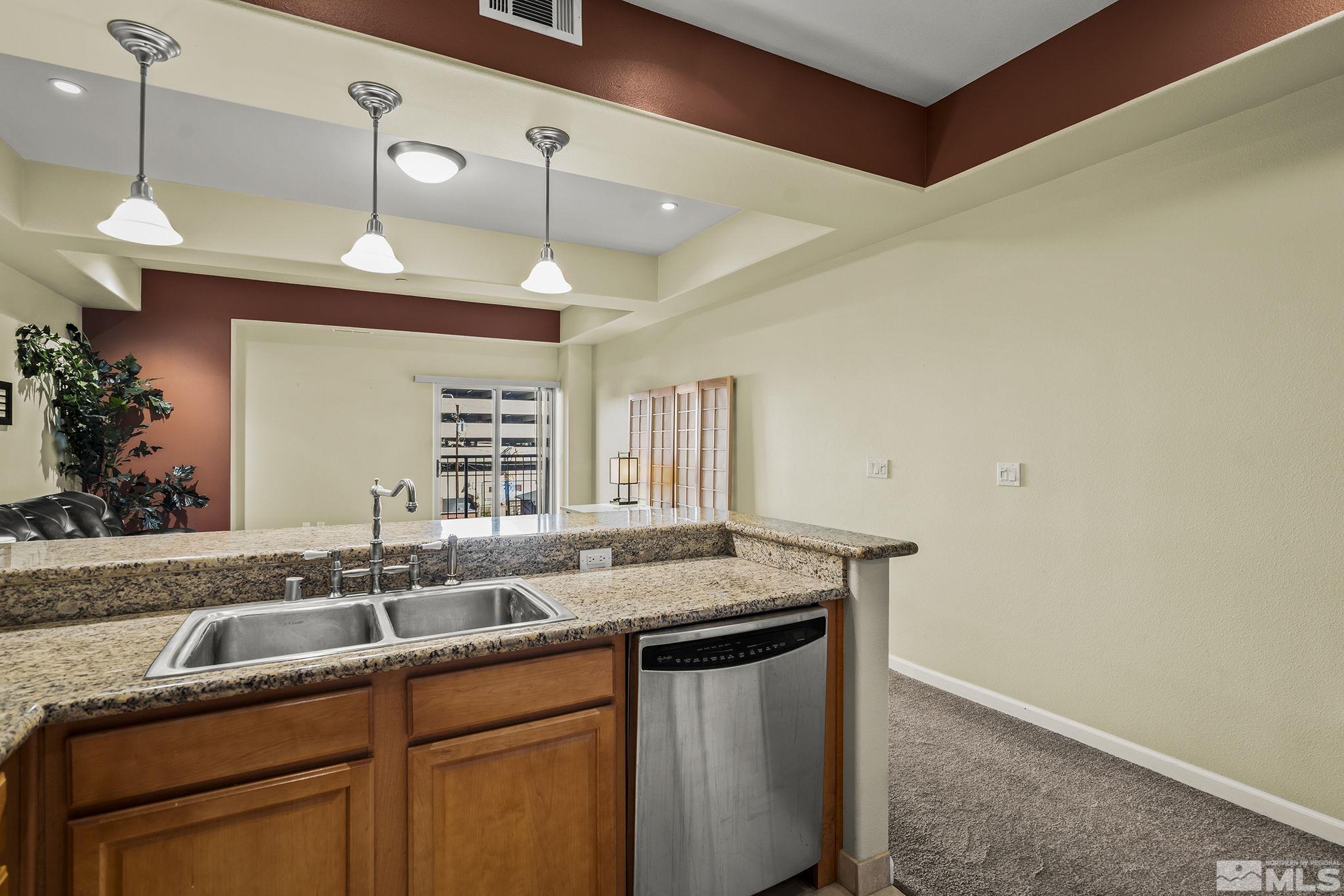 200 West 2nd Street, Unit 202 Reno, NV 89501 - Photo 6 of 18 a kitchen with a sink and a refrigerator