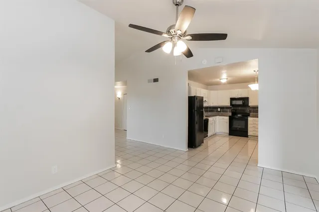a view of a kitchen with a sink and a refrigerator