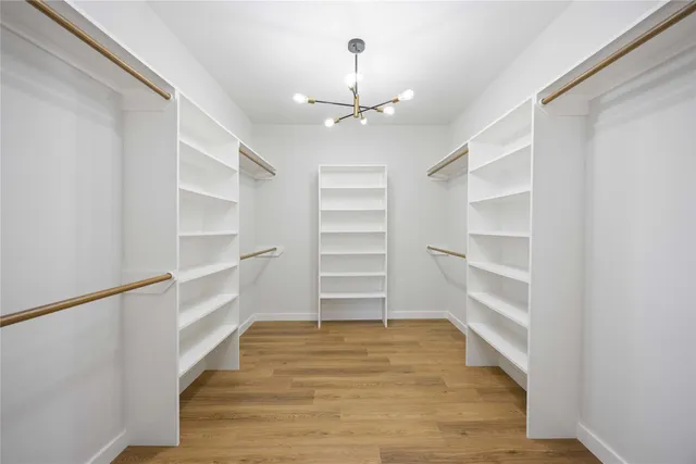 a view of a room with a ceiling fan a wooden floor and ceiling fan