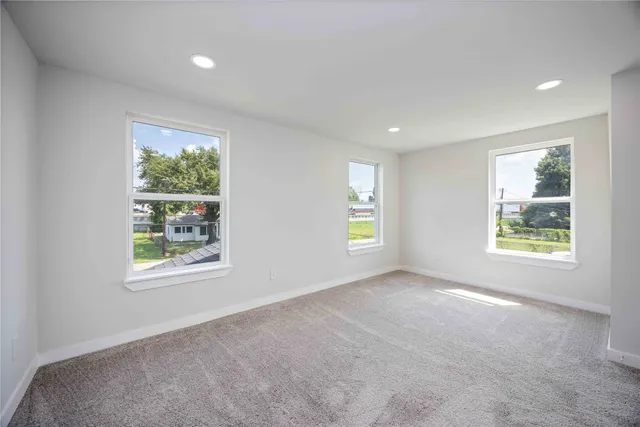 an empty room with windows and closet