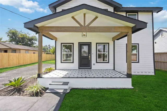 a front view of a house with a garden and a patio
