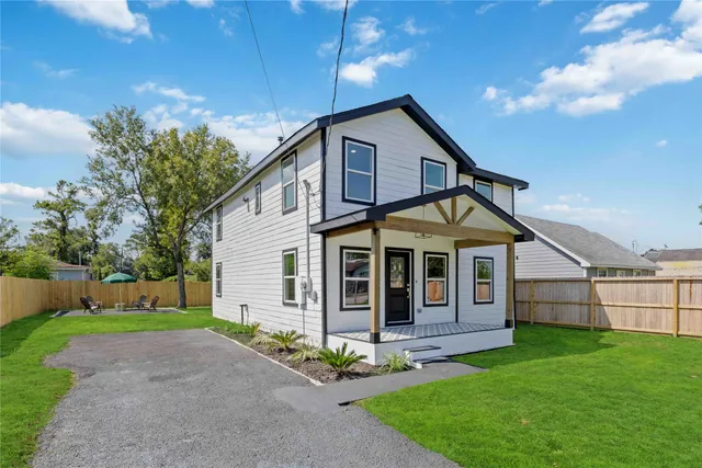 a front view of a house with a garden and yard