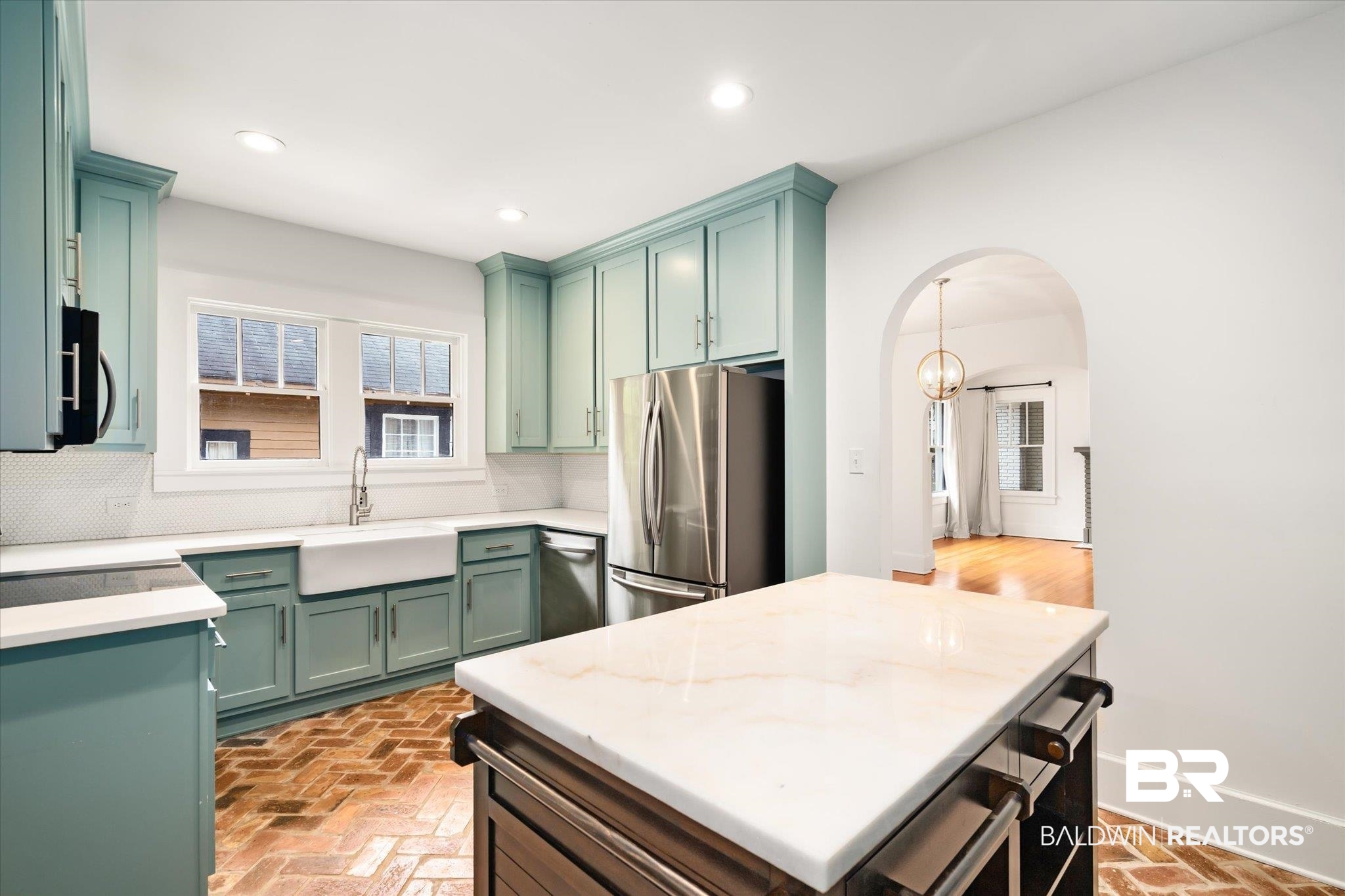 308 South Ann Street Mobile, AL 36604 - Photo 8 of 30 Kitchen featuring green cabinetry, a center island, sink, decorative backsplash, and appliances with stainless steel finishes