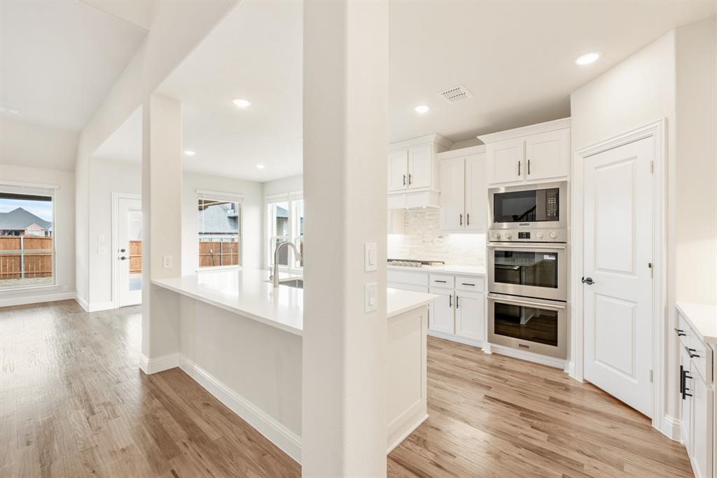2304 Prosper Way Mansfield, TX 76063 - Photo 11 of 39 a view of kitchen with wooden floor and electronic appliances