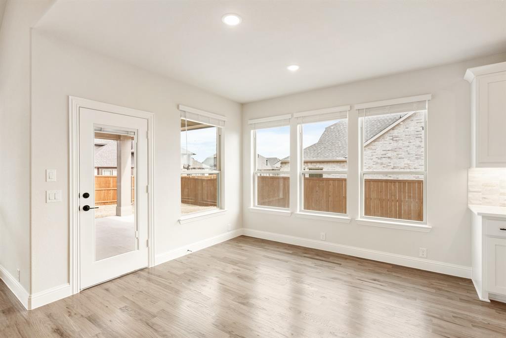 2304 Prosper Way Mansfield, TX 76063 - Photo 15 of 39 an empty room with wooden floor and windows