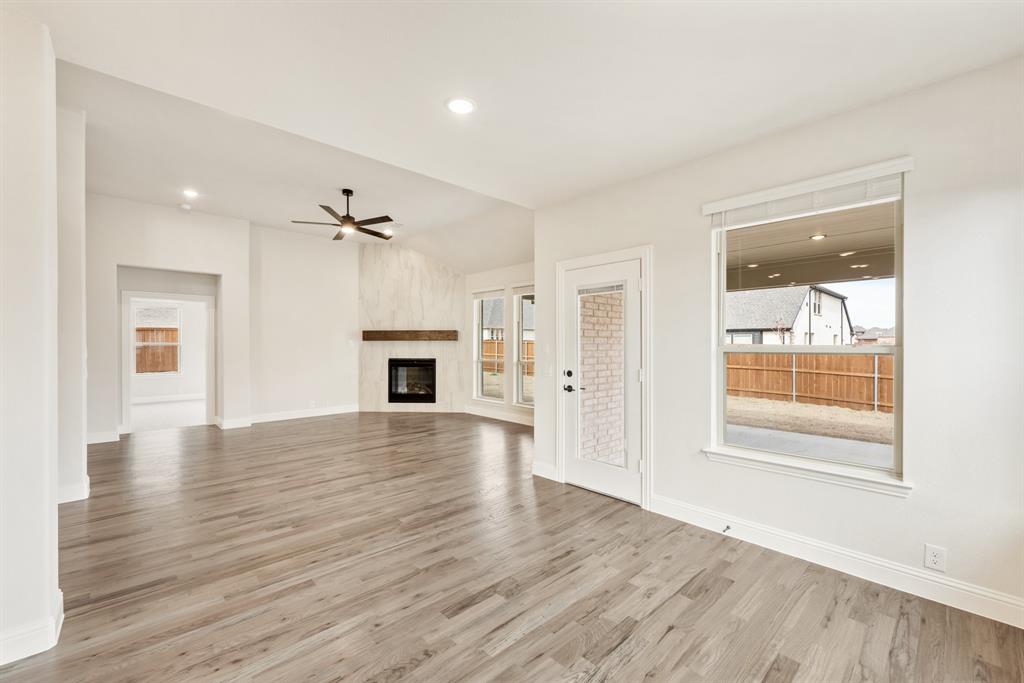 2304 Prosper Way Mansfield, TX 76063 - Photo 16 of 39 a view of an empty room with a window and wooden floor