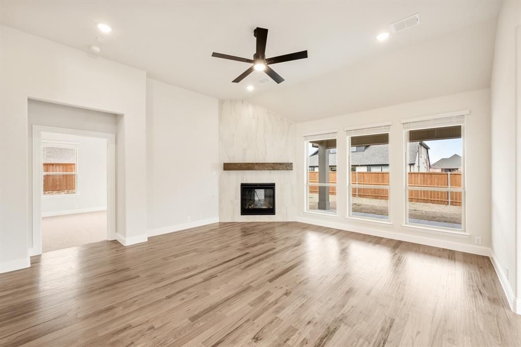 2304 Prosper Way Mansfield, TX 76063 - Photo 20 of 39 a view of an empty room with wooden floor and a window