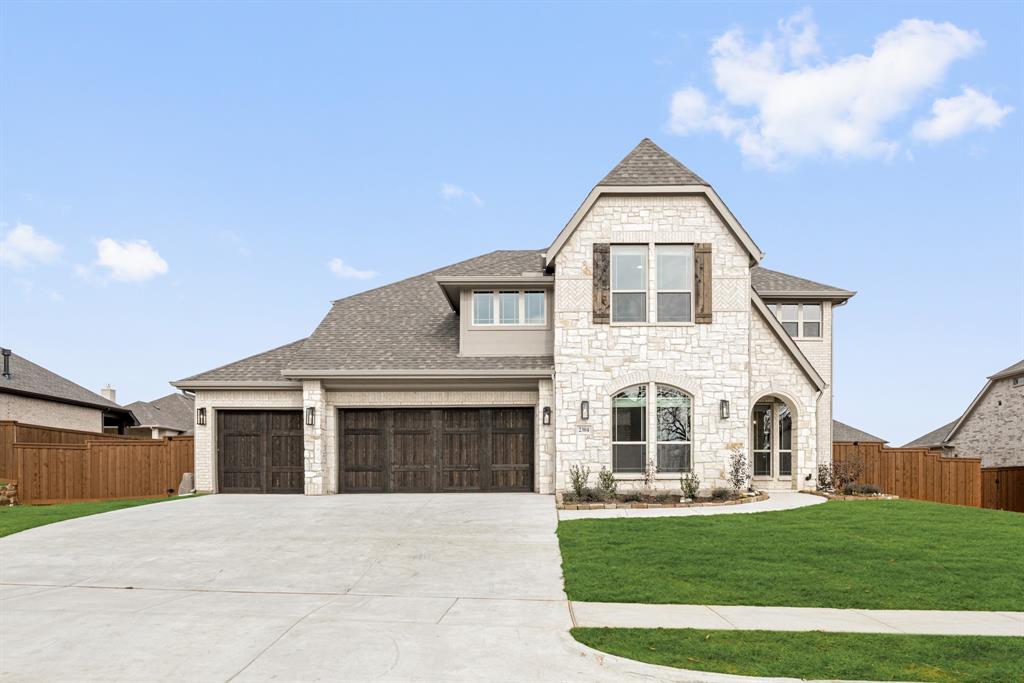 2304 Prosper Way Mansfield, TX 76063 - Photo 2 of 39 a front view of a house with a garden