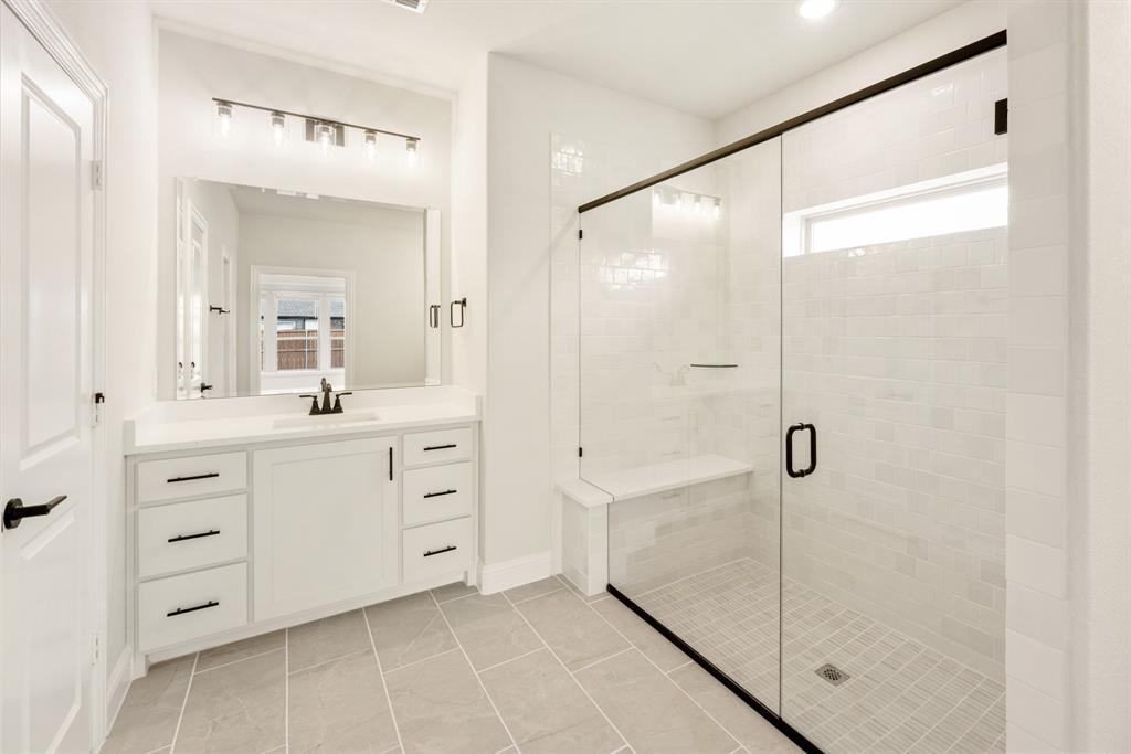 2304 Prosper Way Mansfield, TX 76063 - Photo 23 of 39 a bathroom with a shower sink and mirror
