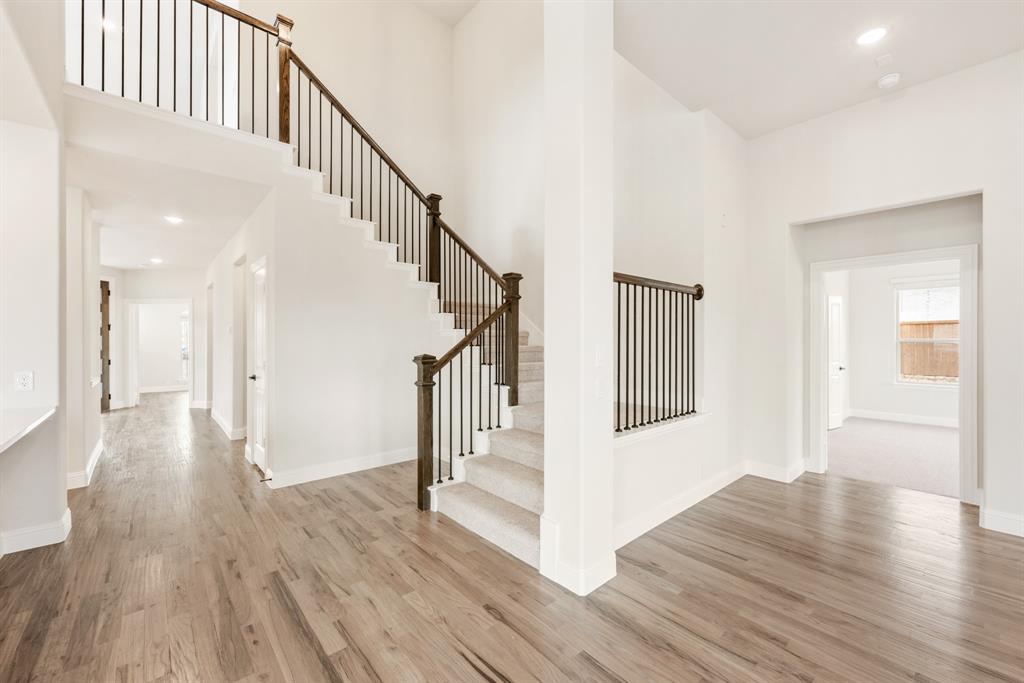 2304 Prosper Way Mansfield, TX 76063 - Photo 25 of 39 a view of staircase with white walls and wooden floor