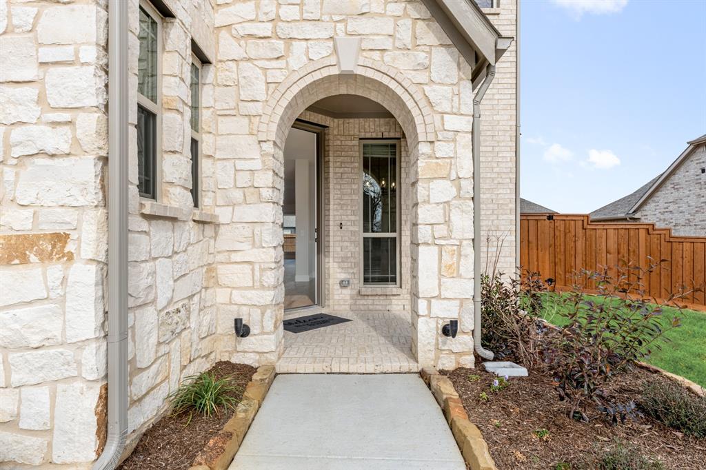 2304 Prosper Way Mansfield, TX 76063 - Photo 4 of 39 a view of a brick house with large windows