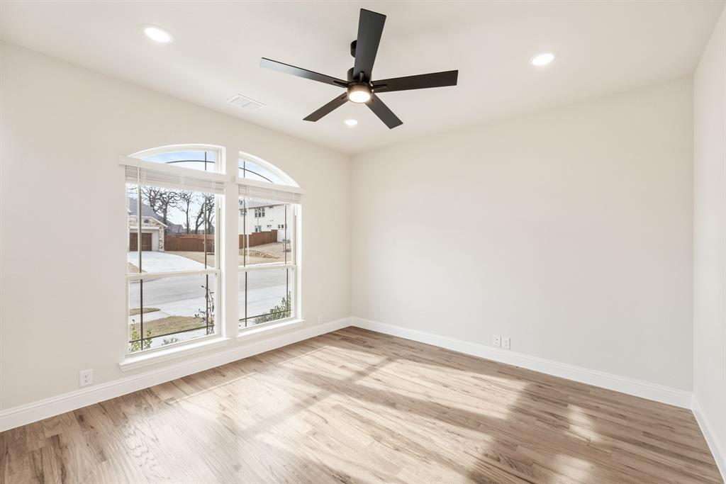 2304 Prosper Way Mansfield, TX 76063 - Photo 6 of 39 an empty room with wooden floor fan and windows