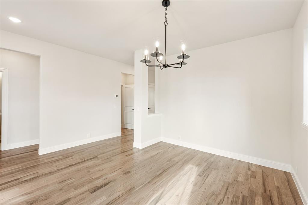 2304 Prosper Way Mansfield, TX 76063 - Photo 10 of 39 a view of a room with wooden floor closet and a window